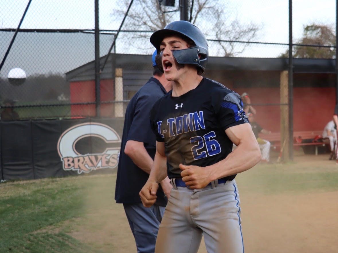 Colt Keen celebrating in an L-Town uniform after crossing the plate